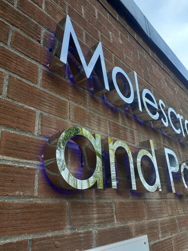 An image of the backlit school sign.